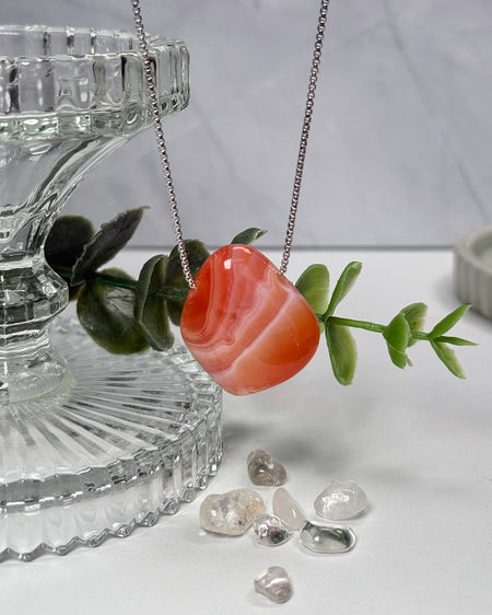 Aprikosenachat, gebohrter Anhänger, 2,7 cm, warm apricotfarbener Naturstein mit sanften Farbschichten.