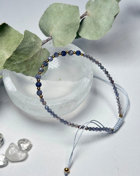 Iolith Armband mit facettierten Perlen und vergoldeten 925er Silberelementen, Makramee-Verschluss, auf hellem Hintergrund